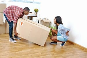 woman moving box getting back ache