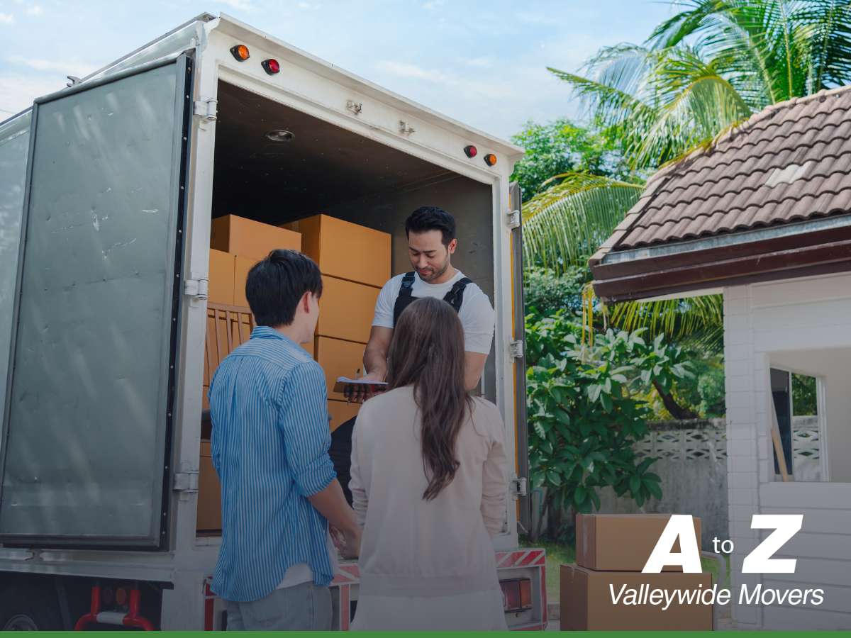 Mover assisting couple with boxes during a Cross-Country Move